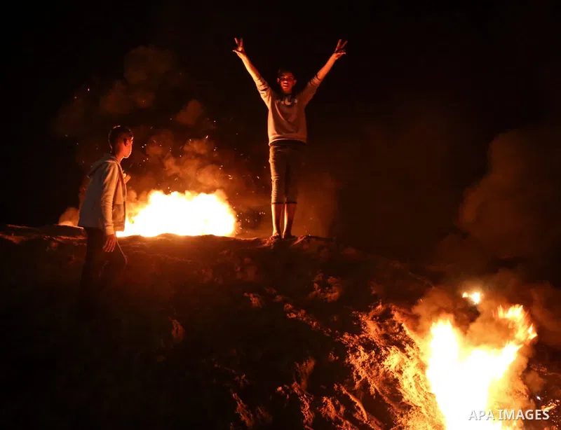 Fire is seen as Palestinian protesters calling themselves the "night confusion units", gather near the Gaza-Israel border east of central Gaza Strip, March 18, 2019. Hundreds of Palestinian protesters, have been organizi...