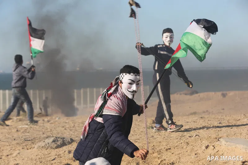Palestinian demonstrators take part in a protest on the beach along the northern Gaza border, across from the Israeli settlement of Kibbutz Zikim, on March19, 2019, as part of weekly maritime protests against the naval b...