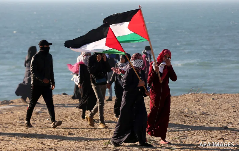 Palestinian demonstrators take part in a protest on the beach along the northern Gaza border, across from the Israeli settlement of Kibbutz Zikim, on March19, 2019, as part of weekly maritime protests against the naval b...