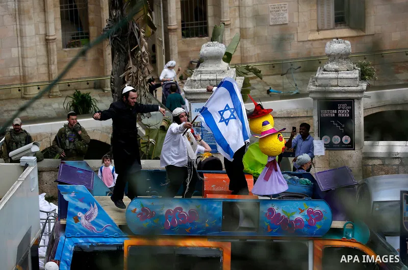 Israeli settlers celebrate the Jewish holiday of Purim, in the West Bank city of Hebron, on March 21, 2019. Purim is a celebration of the Jews' salvation from genocide in c, as recounted in the Book of Esther. Photo by W...