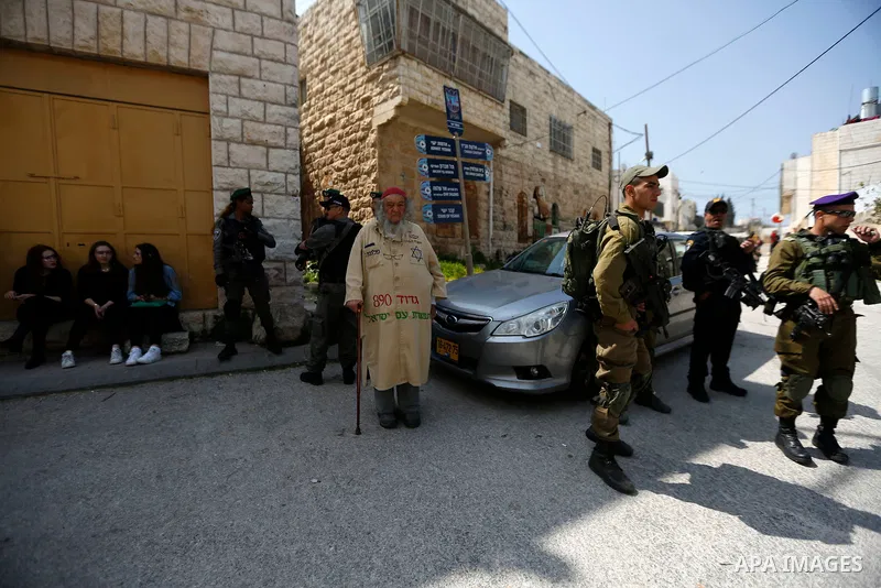 Israeli settlers celebrate the Jewish holiday of Purim, in the West Bank city of Hebron, on March 21, 2019. Purim is a celebration of the Jews' salvation from genocide in c, as recounted in the Book of Esther. Photo by W...