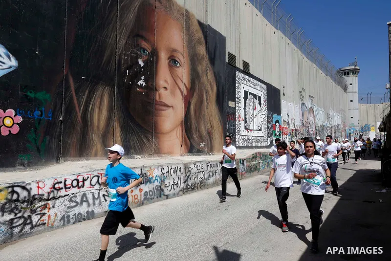 Palestinian and foreign activsts take part in the Palestine Marathon, in the West Bank city of Bethlehem, Friday, March 22, 2019. Palestine seventh international marathon kicked off this morning in Bethlehem with the par...