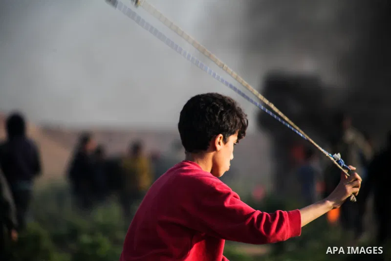 Palestinian protesters clash with Israeli troops following the tents protest where Palestinians demand the right to return to their homeland at the Israel-Gaza border, in Jabalia in the northern Gaza Strip, March 22, 201...