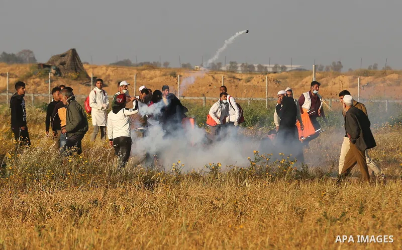 Palestinian protesters clash with Israeli troops following the tents protest where Palestinians demand the right to return to their homeland at the Israel-Gaza border, in Khan Younis in the southern Gaza Strip, March 22,...