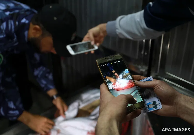 A policeman inspects the body of Jihad Harara, 23, who was killed by Israeli troops in clashes at Gaza-Israel border, at the morgue of Al-Shifa hospital in Gaza city, March 22, 2019. Two Palestinians were killed by Israe...