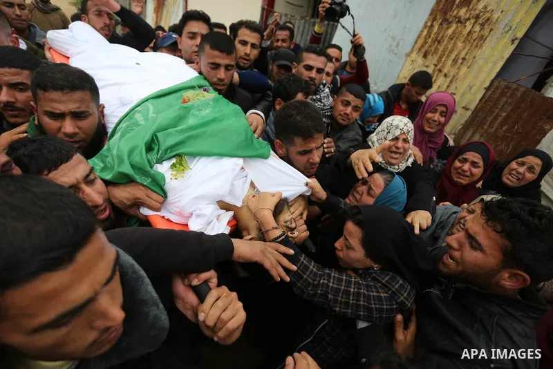 Mourners carry the body of Palestinian Habib Al Masry, 24, who was shot dead by Israeli forces during clashes with Israeli troops in tents protest where Palestinians demand the right to return to their homeland at the Is...
