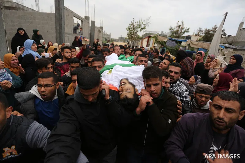 Mourners carry the body of Palestinian Habib Al Masry, 24, who was shot dead by Israeli forces during clashes with Israeli troops in tents protest where Palestinians demand the right to return to their homeland at the Is...