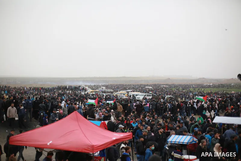 Palestinian protesters gather during a demonstration demand the right to return to their homeland at the Israel-Gaza border in the east of Gaza city on March 30, 2019. Two Palestinians killed and many injuries among thou...