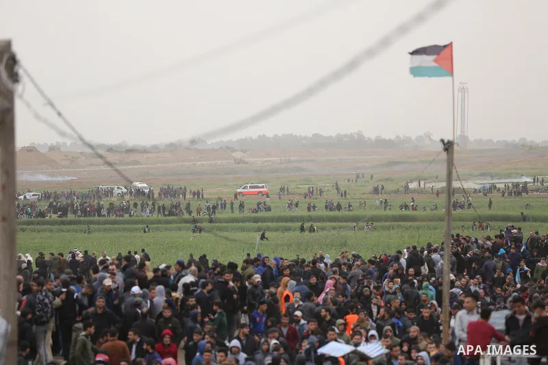 Palestinian protesters gather during a demonstration demand the right to return to their homeland at the Israel-Gaza border in the east of Gaza city on March 30, 2019. Two Palestinians killed and many injuries among thou...