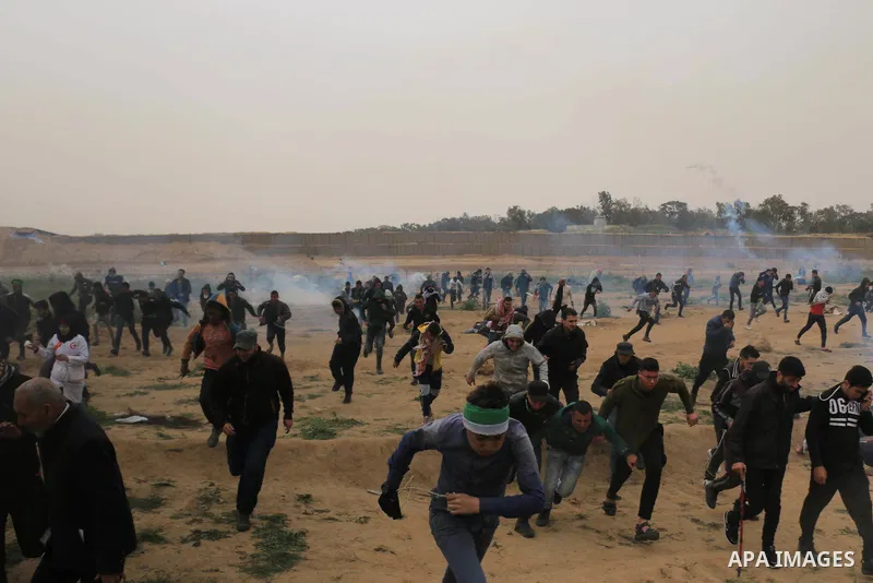 Palestinian protesters gather during a demonstration demand the right to return to their homeland at the Israel-Gaza border in the central of Gaza Strip on March 30, 2019. Four Palestinians killed and many injuries among...