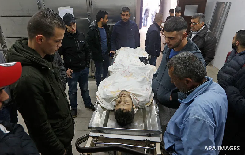 Relatives of Palestinian Mohamad Edwan, 23, who was killed by Israeli security forces, mourn over his body at the morgue of the Palestine Medical Complex, in the West Bank city of Ramallah, on April 2, 2019. Photo by Bah...