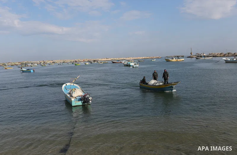 Palestinian fishermen work on their fishing boats, at Gaza seaport, on April 2, 2019. Israel decided to expand the allowed fishing area to 6 nautical miles in northern Gaza Strip, 12 miles in central Gaza Strip and 15 mi...