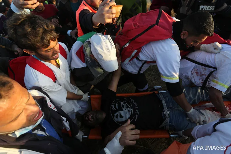 A wounded Palestinian protester is evacuated during clashes with Israeli troops following the tents protest where Palestinians demand the right to return to their homeland at the Israel-Gaza border, in Khan Younis in the...