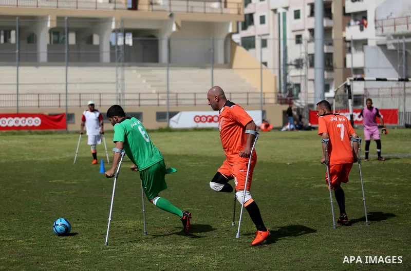 Palestinian amputees using crutches play a football match during the first football tournament for amputees, at Palestine Stadium in Gaza city, on April 13, 2019. More than 125 have had amputations shot by Israeli forces...