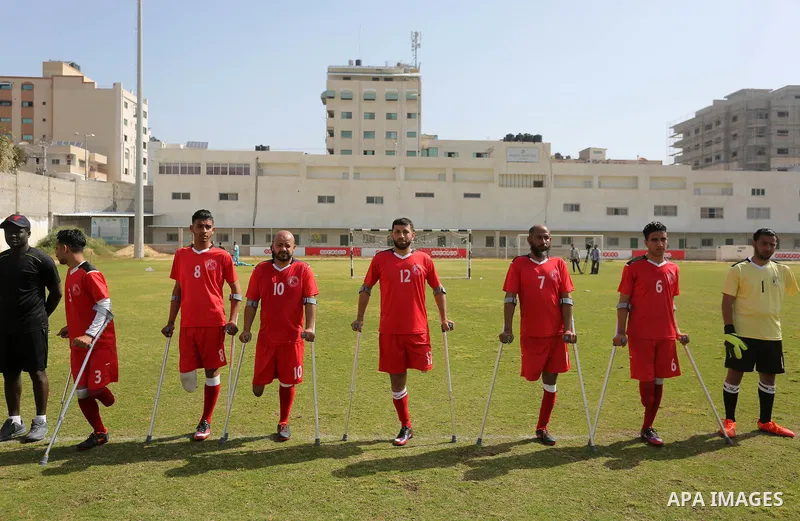 Palestinian amputees using crutches play a football match during the first football tournament for amputees, at Palestine Stadium in Gaza city, on April 13, 2019. More than 125 have had amputations shot by Israeli forces...