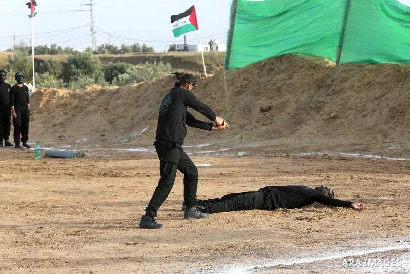 Palestinian militants of al-Mujahideen Brigades, show their military skills during a graduation ceremony, in Gaza city on April 24, 2019. Photo by Ashraf Amra