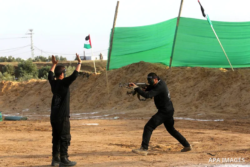 Palestinian militants of al-Mujahideen Brigades, show their military skills during a graduation ceremony, in Gaza city on April 24, 2019. Photo by Ashraf Amra
