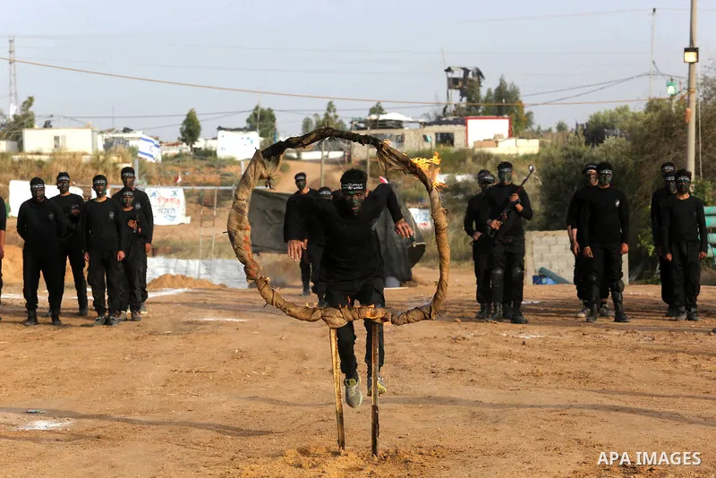 Palestinian militants of al-Mujahideen Brigades, show their military skills during a graduation ceremony, in Gaza city on April 24, 2019. Photo by Ashraf Amra