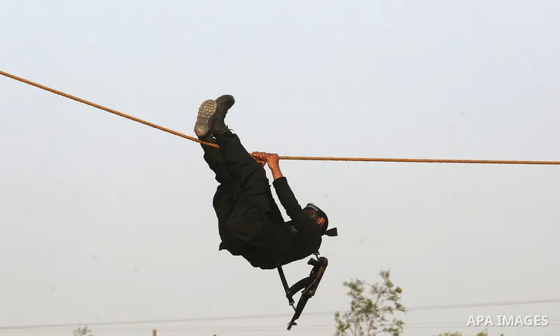 Palestinian militants of al-Mujahideen Brigades, show their military skills during a graduation ceremony, in Gaza city on April 24, 2019. Photo by Ashraf Amra