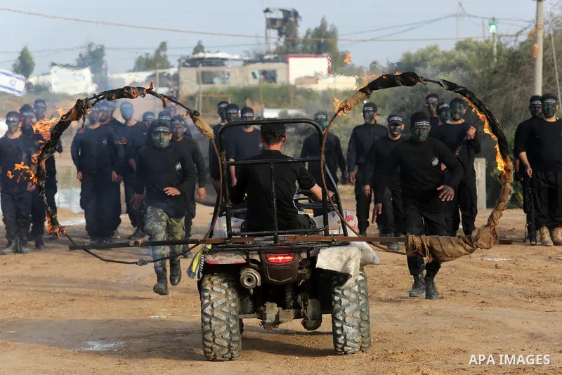Palestinian militants of al-Mujahideen Brigades, show their military skills during a graduation ceremony, in Gaza city on April 24, 2019. Photo by Ashraf Amra