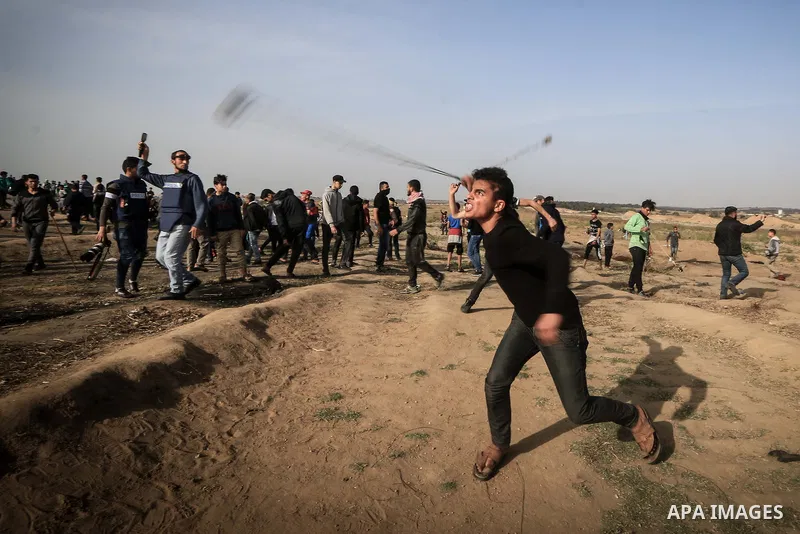 Palestinian protesters clash with Israeli troops following the tents protest where Palestinians demand the right to return to their homeland at the Israel-Gaza border, in the central Gaza Strip, April 26, 2019. The Pales...
