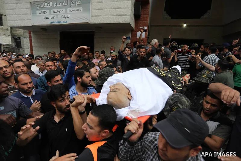 Mourners carry the body of Palestinian, who was killed in Israeli strikes during his funeral in Beit Lahia in the northern Gaza Strip on May 6, 2019. The Israeli attack on the Gaza Strip left 25 Palestinians dead and at...