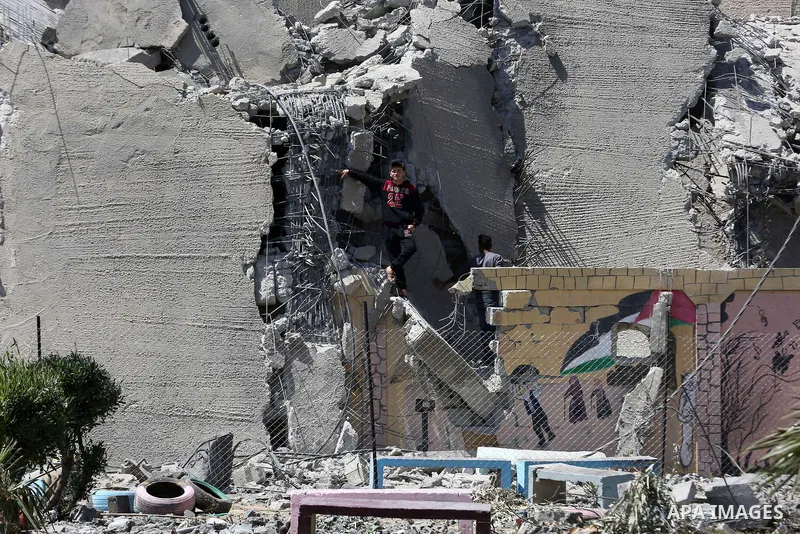 Palestinians clean al-Sayeda Roqaya School that demolished in an Israeli airstrike, in Gaza City on May 8, 2019. About 130 residential apartments were completely destroyed, while 700 others were partially destroyed in th...