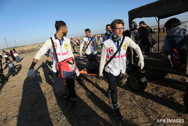 A wounded Palestinian protester is evacuated during clashes with Israeli troops following the tents protest where Palestinians demand the right to return to their homeland at the Israel-Gaza border, in Khan Younis in the...