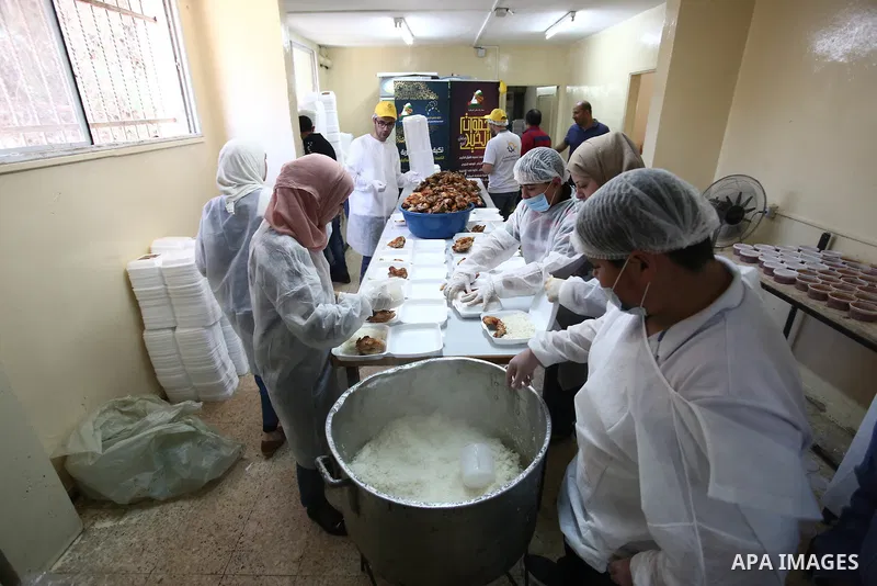 Palestinians prepare food to be distributed for free during the holy fasting month of Ramadan in the West Bank city of Nablus, on May 11, 2019. The "Nablus Charity Takiya", was founded seven years ago providing 1500 meal...