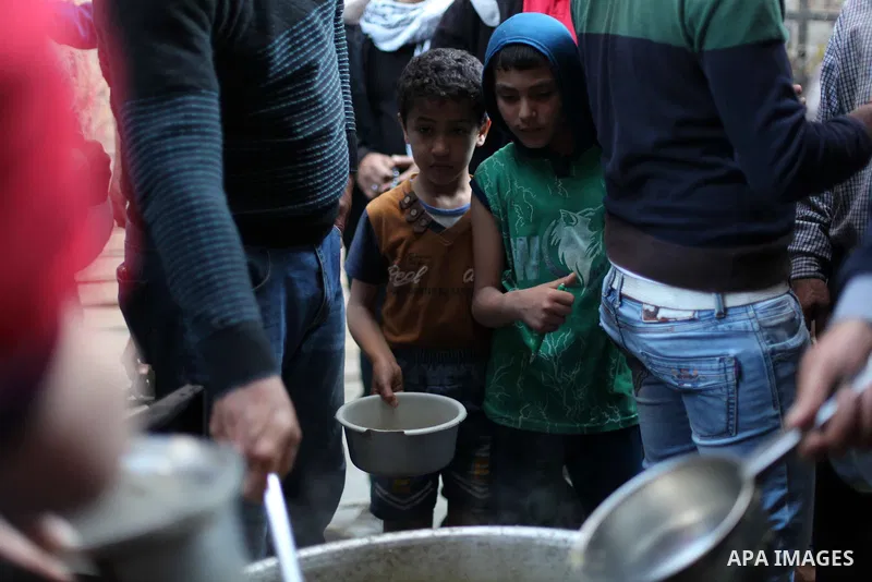 Palestinians wait receive free food during the holy fasting month of Ramadan, in al-Shijaiyah destrict, in Gaza city on May 11, 2019. Muslims around the world celebrate the holy month of Ramadan by praying during the nig...