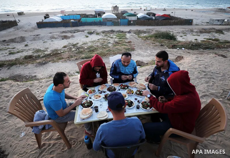 Palestinians break their fast at the beach of Gaza city during the holy fasting month of Ramadan, on May 11, 2019. Muslims around the world celebrate the holy month of Ramadan by praying during the night time and abstain...