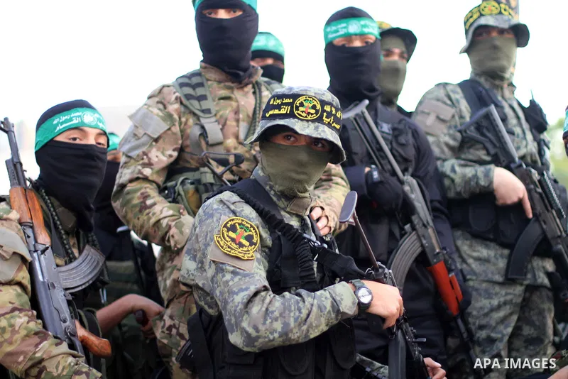 Palestinian militants of Ezzeddin al-Qassam brigades, loyal to Hamas movement, and Al-Quds brigades, loyal to Islamic Jihad movement, distribute dates and water to Palestinians, in Gaza city on May 14, 2019. Qatar will c...