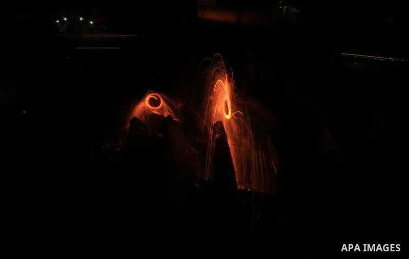 Palestinian children play with fireworks on the rubble of a destroyed building, during holy fasting month of Ramadan, in Gaza city on May 14, 2019. Muslims around the world celebrate the holy month of Ramadan by praying...