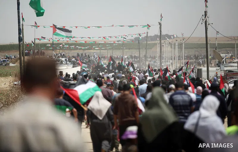 Palestinian demonstrators gather during a protest marking 71th anniversary of Nakba also known as Day of the Catastrophe in 1948, near the border fence east of Gaza City in the Gaza Strip on May 15, 2019. Photo by Mahmou...