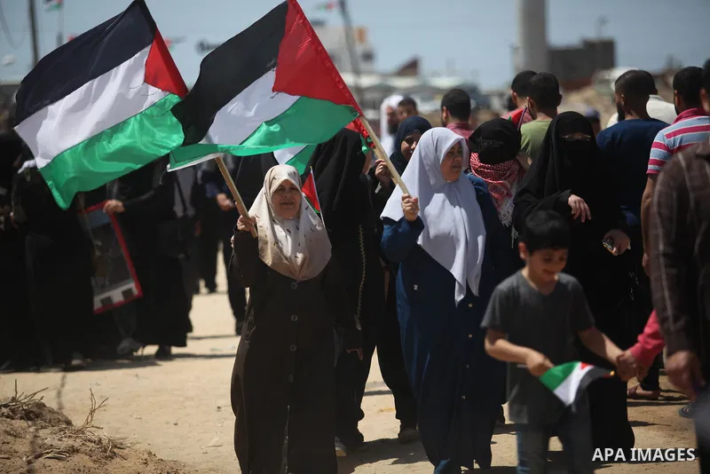 Palestinian demonstrators gather during a protest marking 71th anniversary of Nakba also known as Day of the Catastrophe in 1948, near the border fence east of Gaza City in the Gaza Strip on May 15, 2019. Photo by Mahmou...