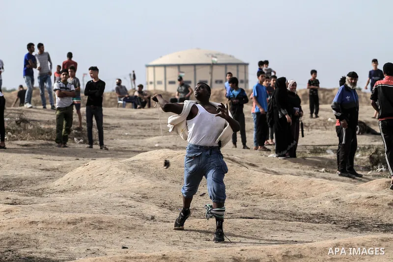 Palestinian protesters clash with Israeli troops following the tents protest where Palestinians demand the right to return to their homeland at the Israel-Gaza border, in the central Gaza Strip, May 23, 2019. Photo by Ma...
