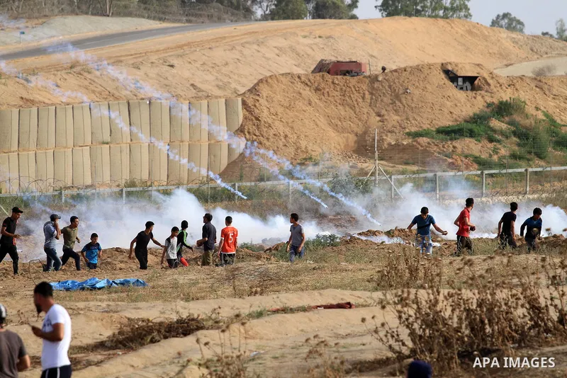 Palestinian protesters clash with Israeli troops following the tents protest where Palestinians demand the right to return to their homeland at the Israel-Gaza border, in the central Gaza Strip, May 23, 2019. Photo by Ma...