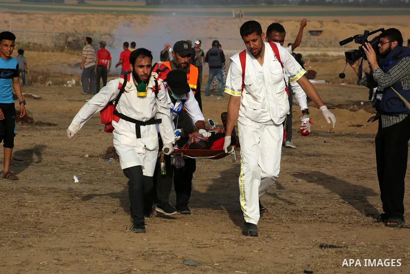 A wounded Palestinian protester is evacuated during clashes with Israeli troops following the tents protest where Palestinians demand the right to return to their homeland at the Israel-Gaza border, in Khan Younis in the...