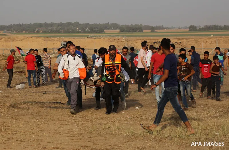 A wounded Palestinian protester is evacuated during clashes with Israeli troops following the tents protest where Palestinians demand the right to return to their homeland at the Israel-Gaza border, in Khan Younis in the...