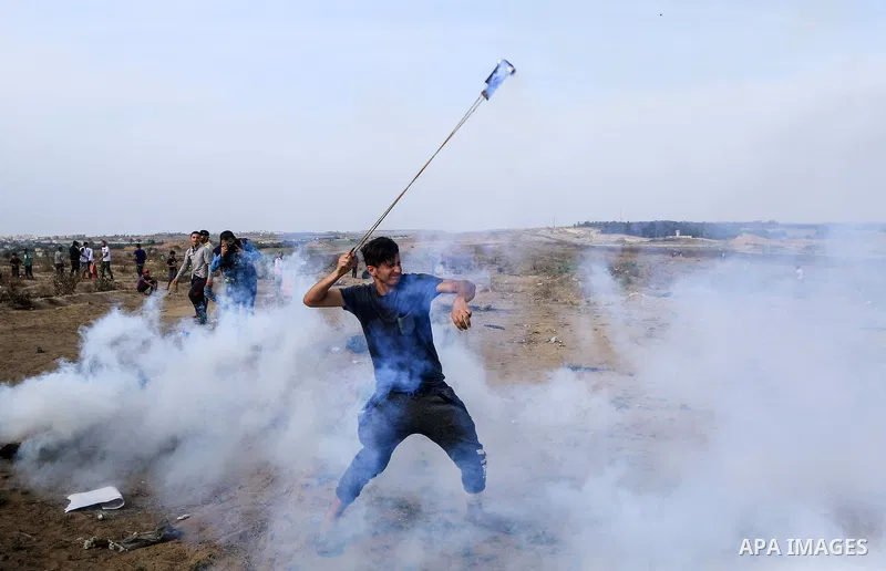 Palestinian protesters clash with Israeli troops following the tents protest where Palestinians demand the right to return to their homeland at the Israel-Gaza border, in the central Gaza Strip, May 31, 2019. Photo by Ma...