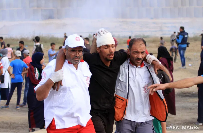 A wounded Palestinian protester is evacuated during clashes with Israeli troops following the tents protest where Palestinians demand the right to return to their homeland at the Israel-Gaza border, in the central Gaza S...