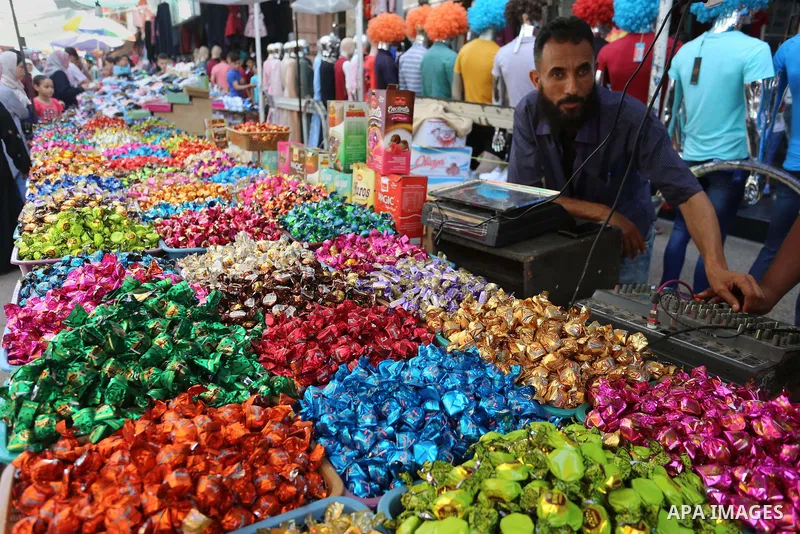 Palestinians gather at a shop selling chocolate at a store a few days ahead of Eid al-Fitr holiday in Gaza city on June 2, 2019. Eid al-Fitr marks the end of Muslim's holy fasting month of Ramadan when faithfuls abstain...