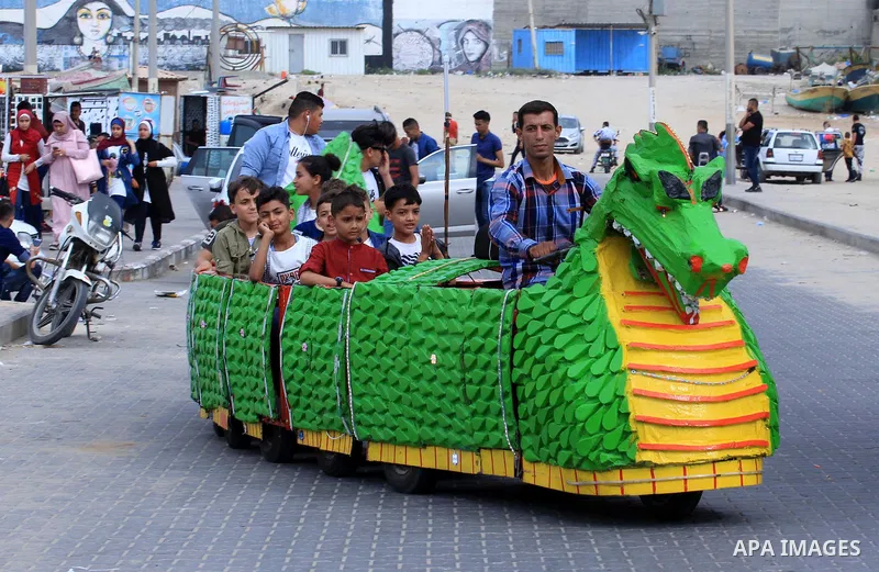 Palestinians celebrate on the second day of Eid al-Fitr holiday which marks the end of the Muslim holy month of Ramadan at Gaza seaport, on June 6, 2019. Photo by Mahmoud Khattab