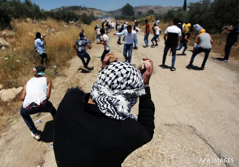 Palestinian protesters clash with Israeli security forces following a protest against the expropriation of Palestinian agricultural land by Israel, in the village of Azmut, near the West Bank city of Nablus on June 28, 2...