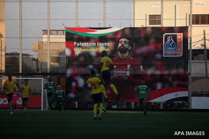 Palestinian players of Khadamat Rafah club (green T-shirt), and players of Shabab Balata club (yellow T-shirt), play during the Palestine cup championship, in Rafah in the southern Gaza Strip on June 30. 2019. The game e...