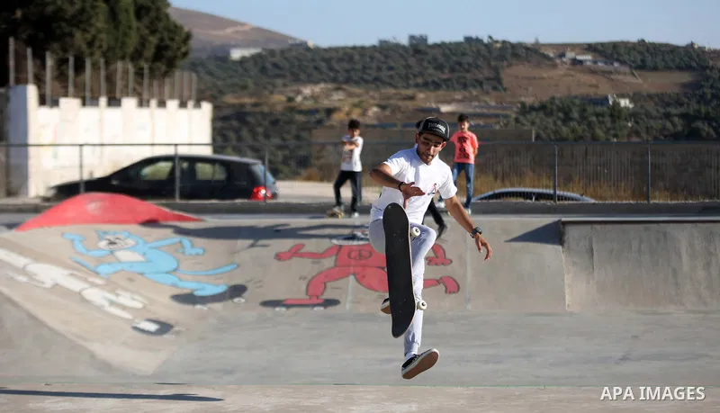 A Palestinian youth skateboards in a skatepark in the village of Asira ash-Shamaliya, near the West Bank city of Nablus, July 02, 2019. Skateboarding is an action sport which involves riding and performing tricks using a...