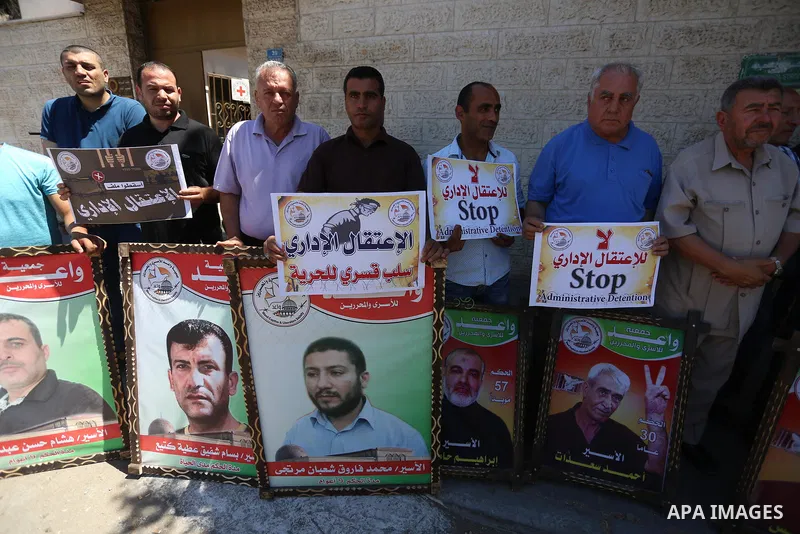 Palestinians hold placards during a protest in solidarity with prisoners on hunger strike against administrative detention, in Gaza city on July 03, 2019. Photo by Ashraf Amra