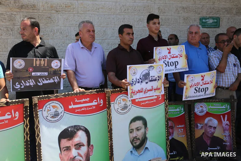 Palestinians hold placards during a protest in solidarity with prisoners on hunger strike against administrative detention, in Gaza city on July 03, 2019. Photo by Ashraf Amra