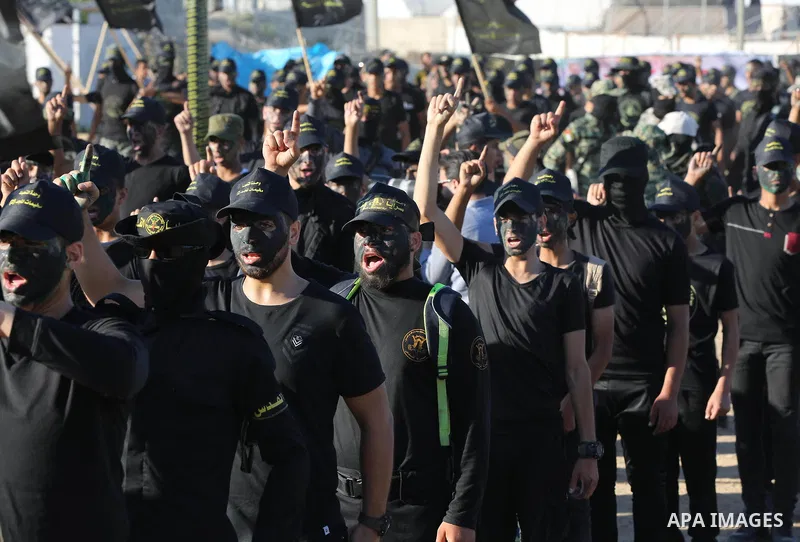 Young Palestinians, carrying a wooden rifle, chants slogans during a military-style graduation ceremony organised by the Islamic Jihad movement in Gaza City on July 4, 2019. Photo by Ashraf Amra
