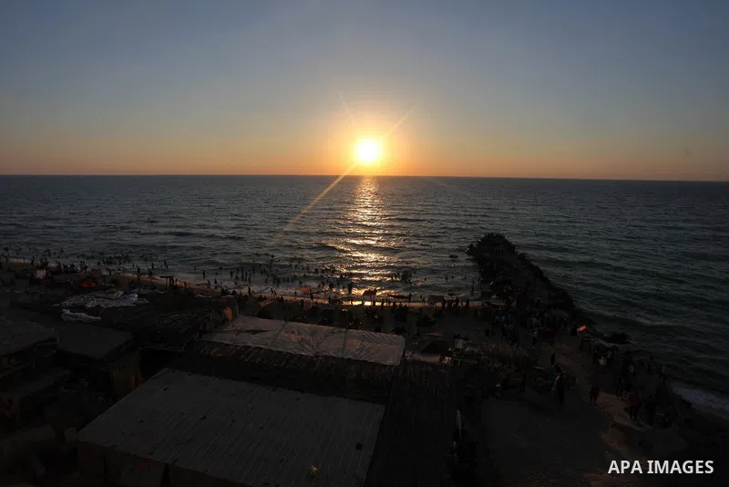 Palestinians enjoy at the beach along the shore of the Mediterranean Sea during the sunset, in Gaza City July 05, 2019. Photo by Mahmoud Ajjour